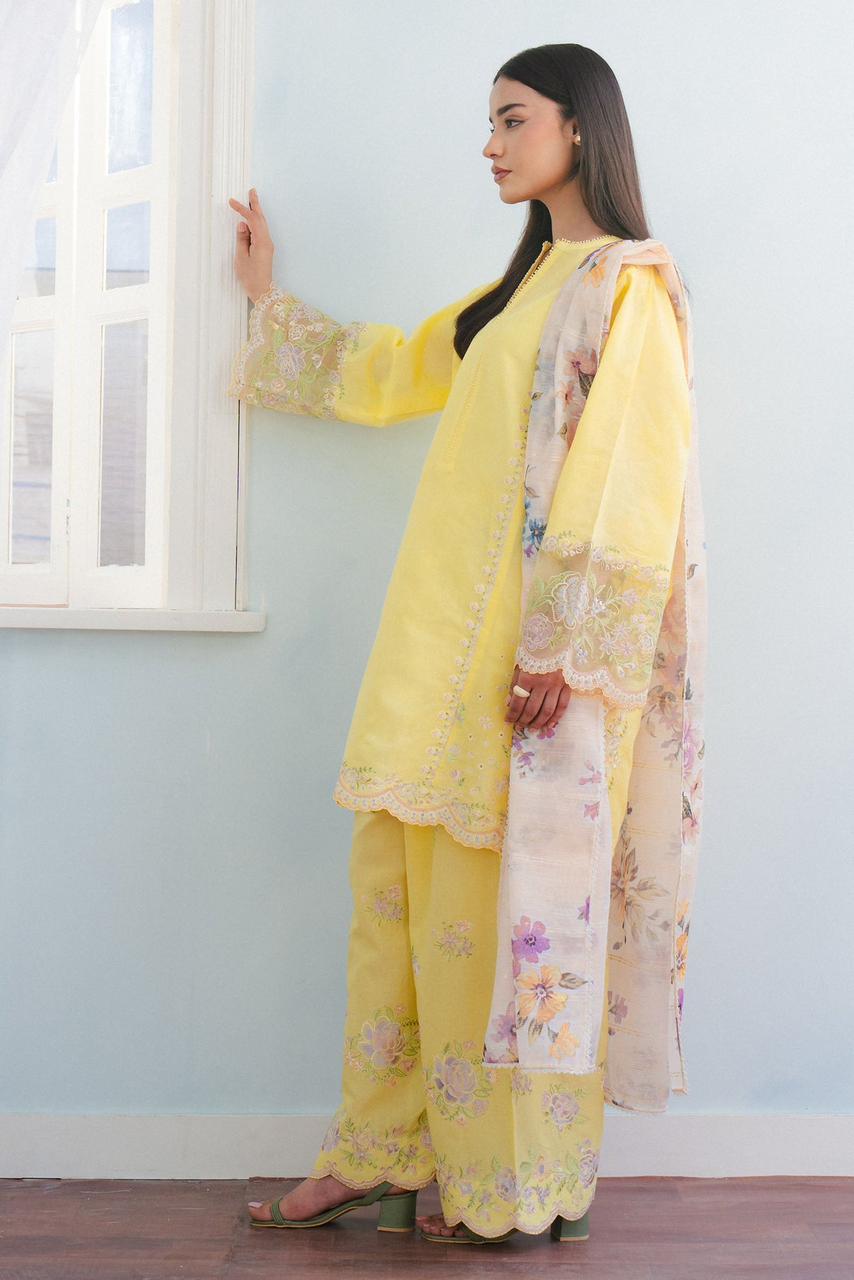 "Side view of COCO yellow lawn suit with embroidered sleeves border and scalloped daman lace"