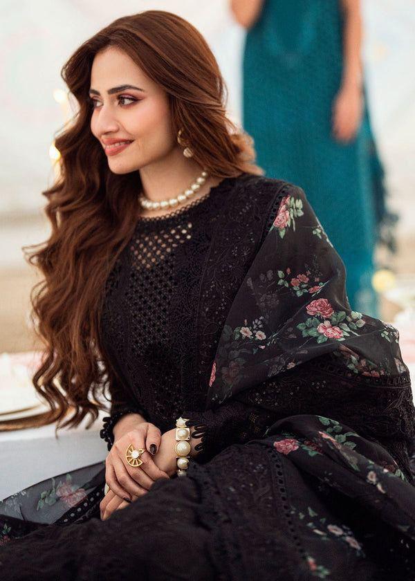 Sana Javed sitting in NUREH black lawn suit with floral organza dupatta