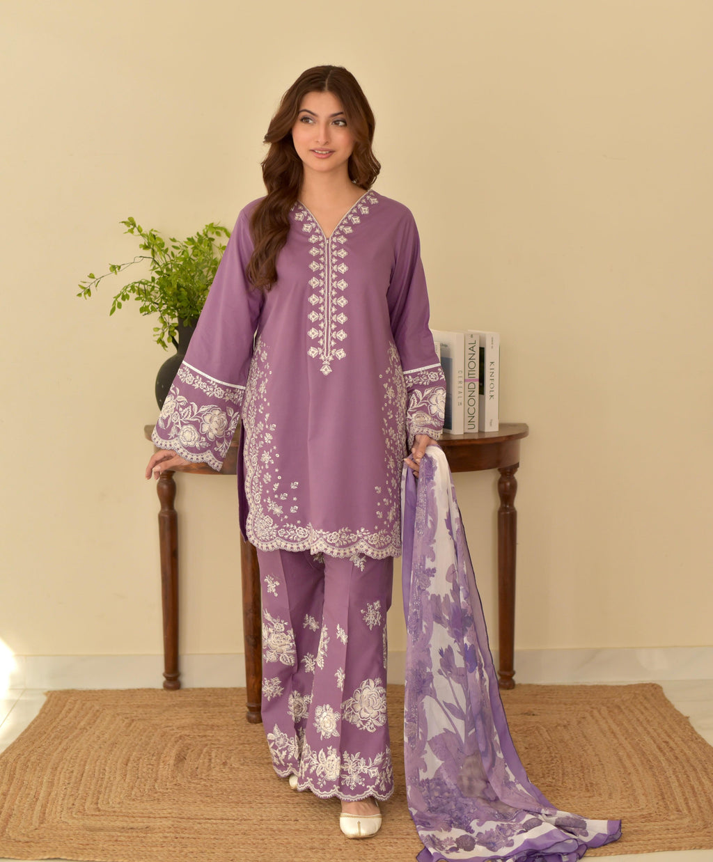 "Full view model in lilac lawn suit with embroidered neckline, heavy sleeve borders and matching embroidered trousers"